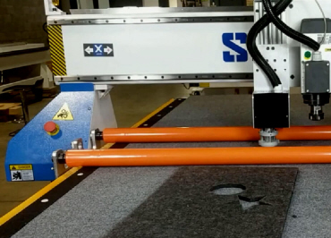 Automated roller hold down